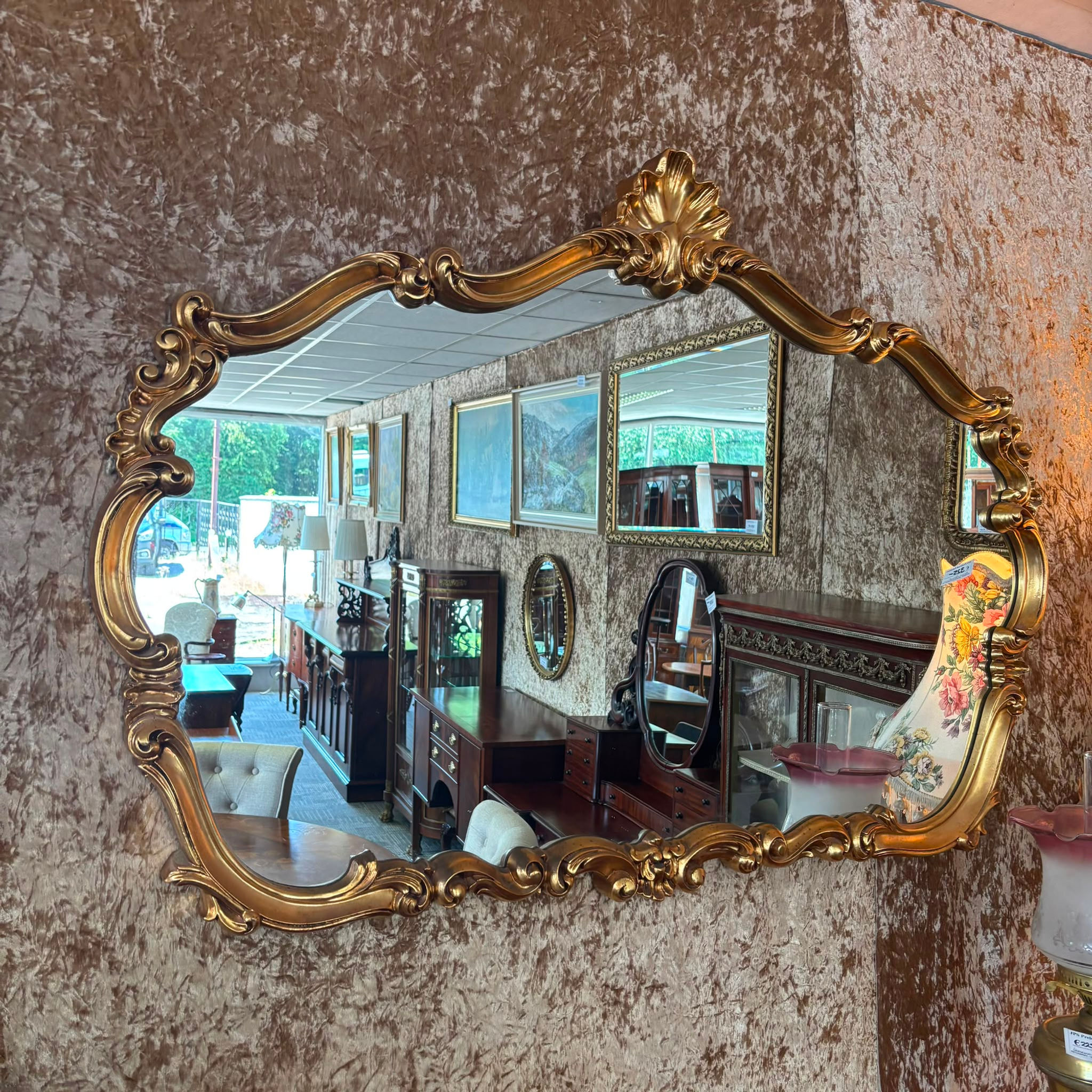 Gilt mirror, arch top Rococo style frame with ornate motifs