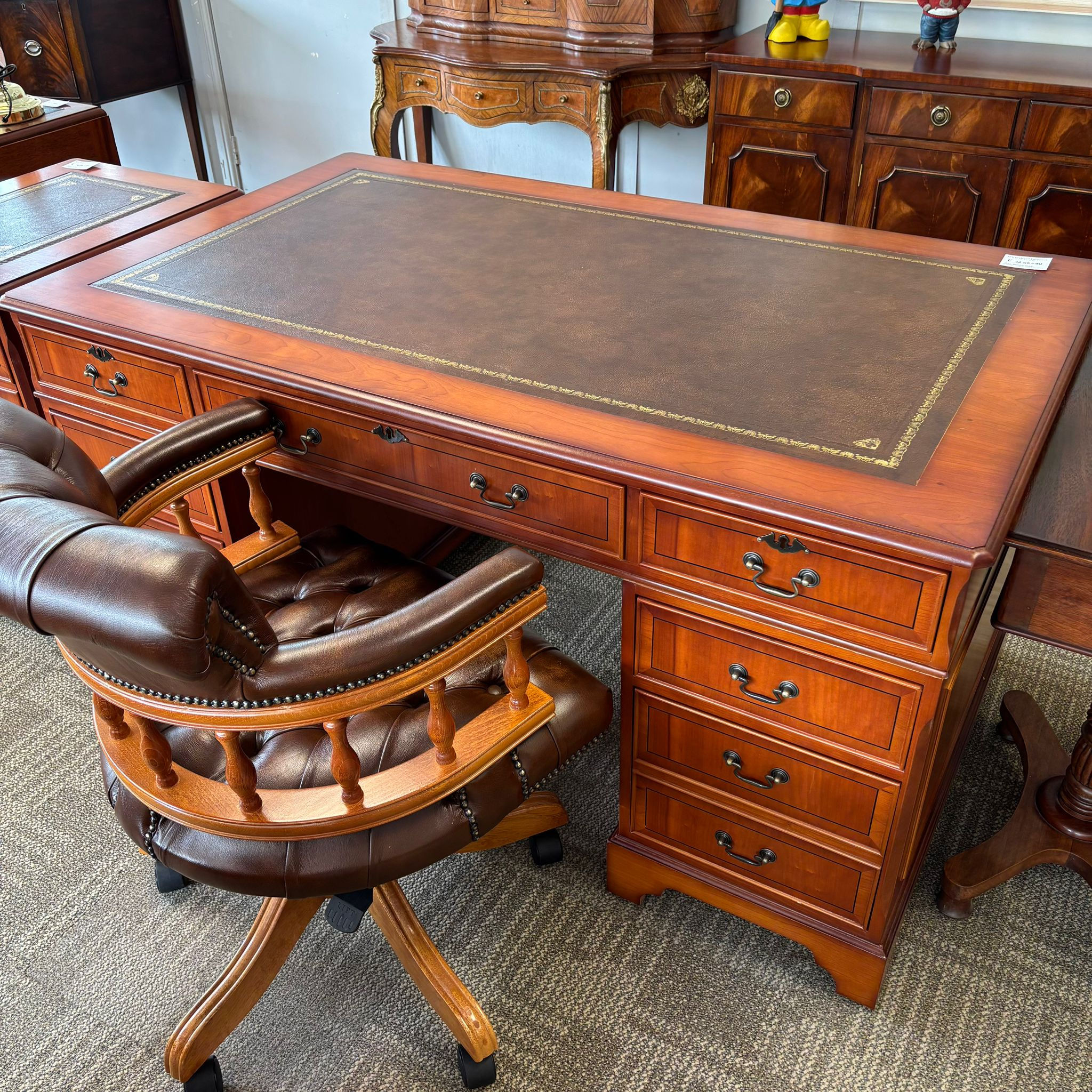 Twin pedestal writing desk with a tan leather top