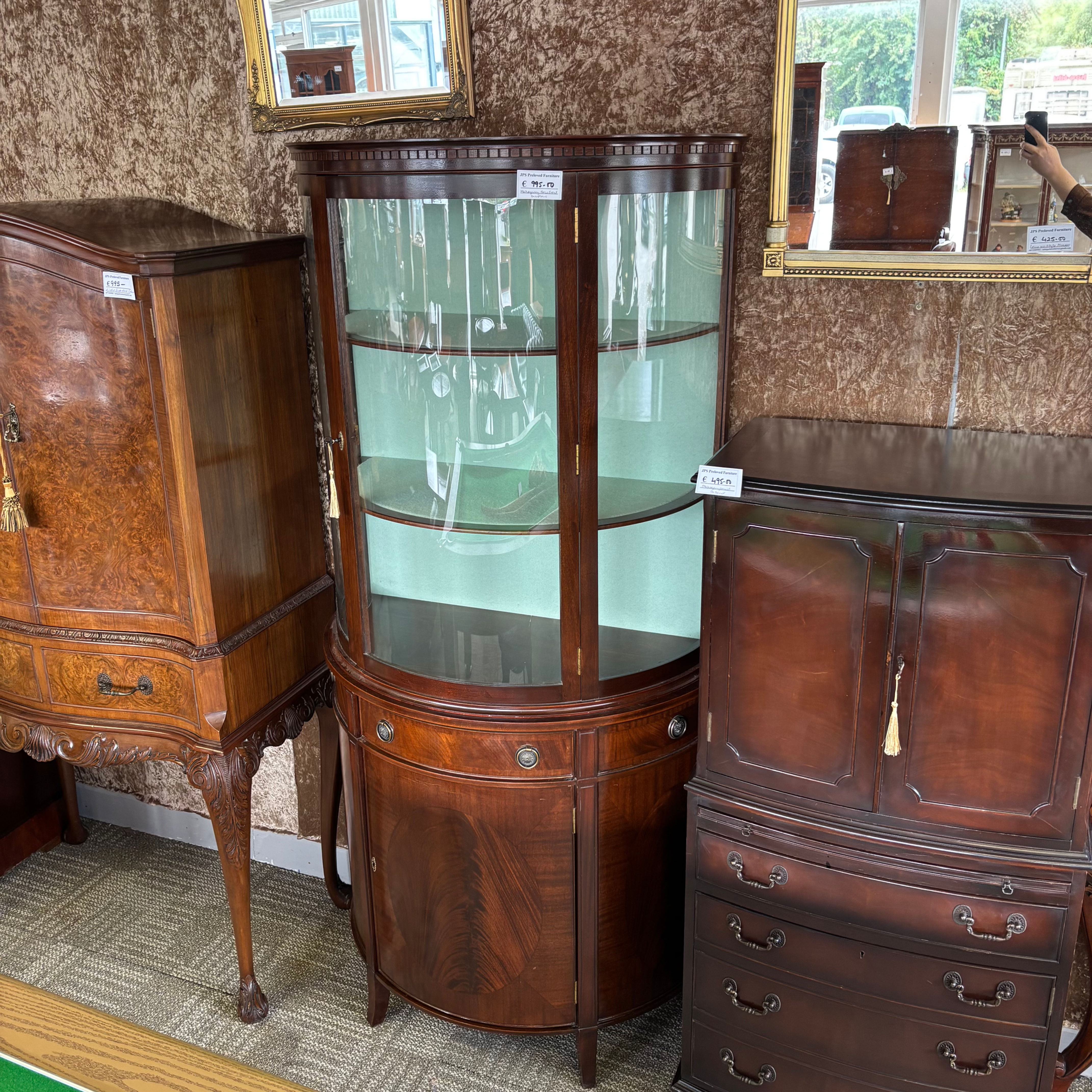 Mahogany bow-front display cabinet with curved glazed top front