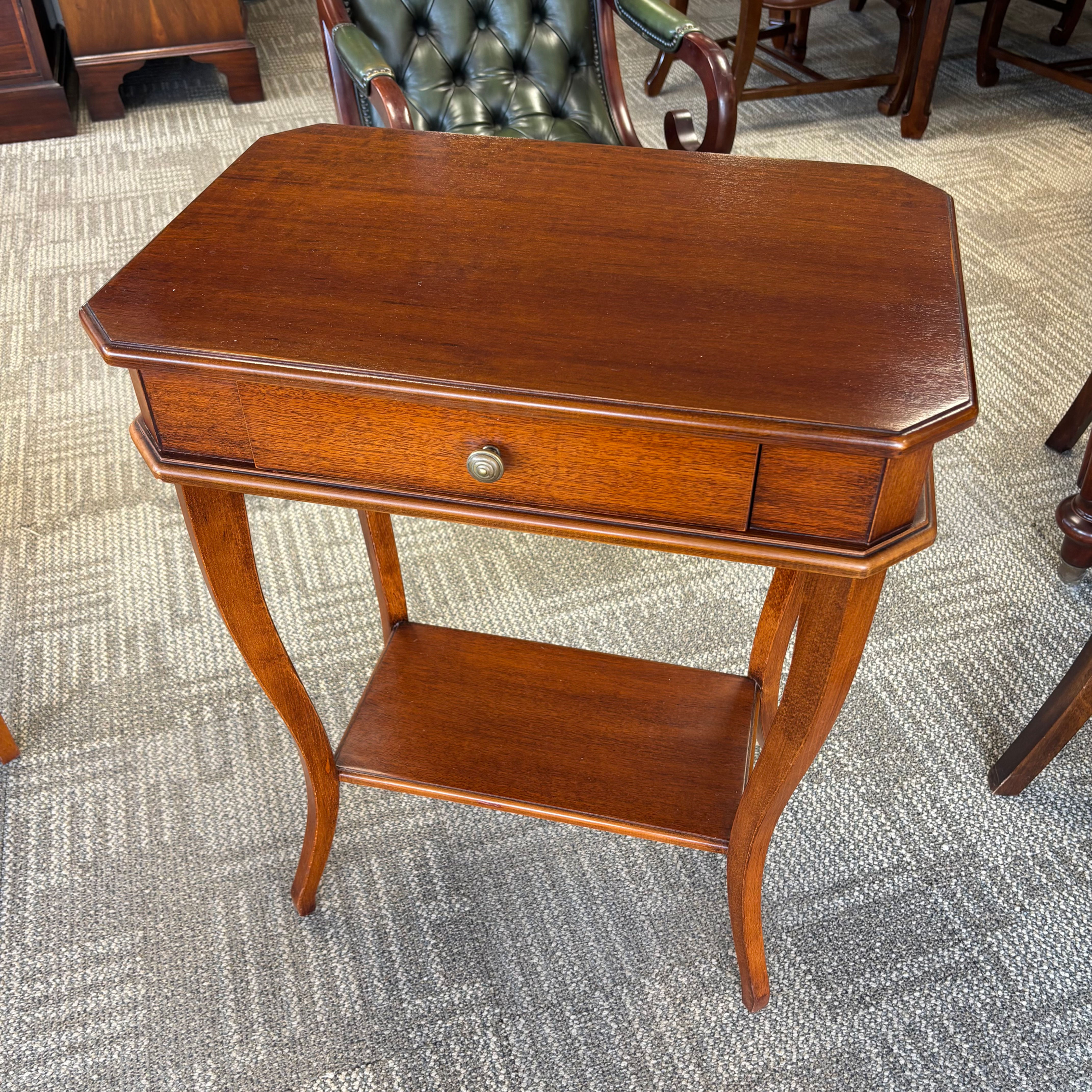 Charming mahogany two-tier side table featuring a practical single drawer