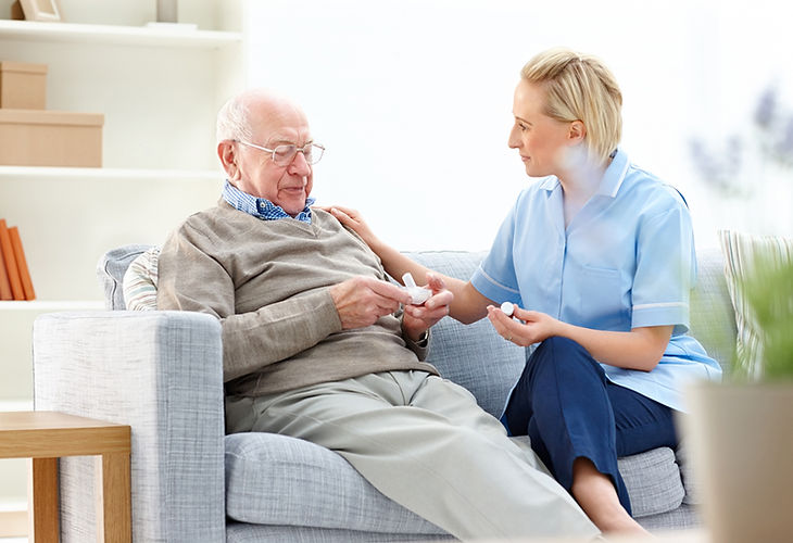 Resident receiving medication from nurse