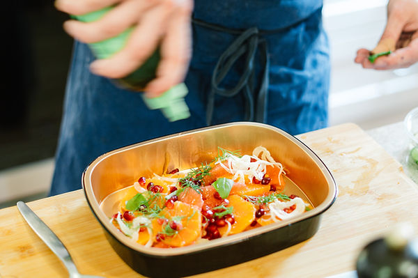 citrus salad being garnished