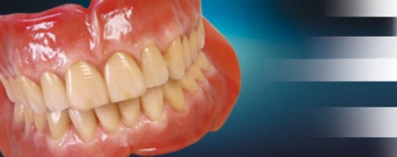 Set of complete dentures on a blue gradient background.jpg
