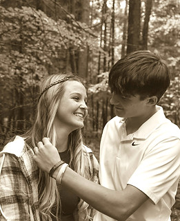 Sepia toned romantic couple portrait in a serene autumn forest capturing candid love and natural beauty perfect for engagement wedding or lifestyle photography inspiration.