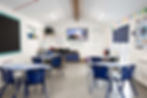 inside a Brearley Hall classroom with table and chairs and work on the walls
