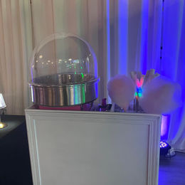 A cotton candy cart with glow cones 