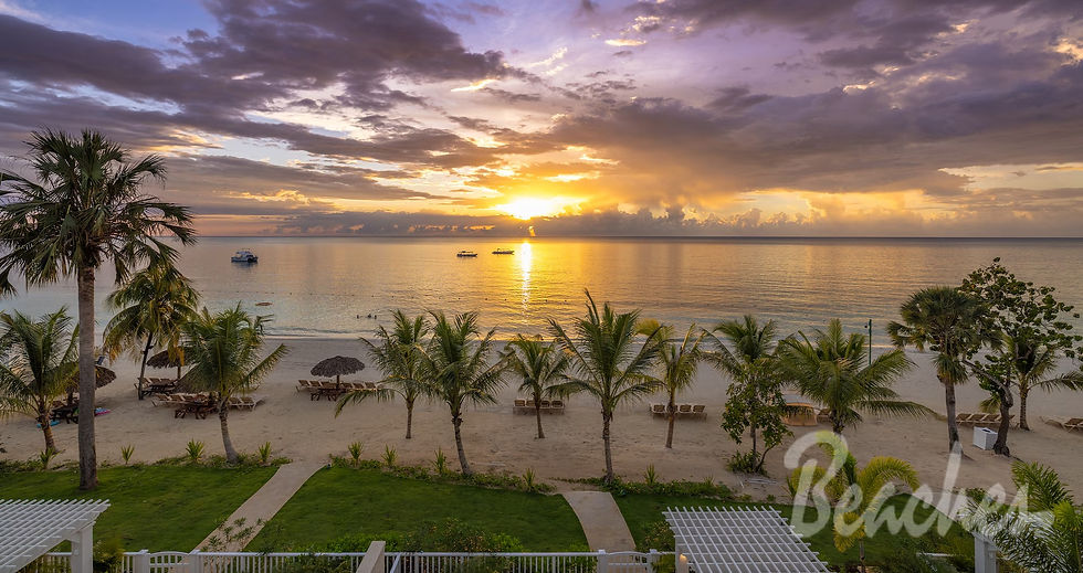 Sunset over a tropical beach with palm trees, boats on calm water, and "Beaches" text. Purple-gray clouds create a serene mood. Beaches Resorts