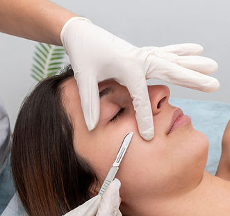 young woman in a beauty center performing a beauty treatment for the skin of the face with