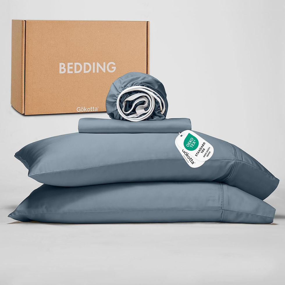 Folded blue bedding set with pillows and a cardboard box