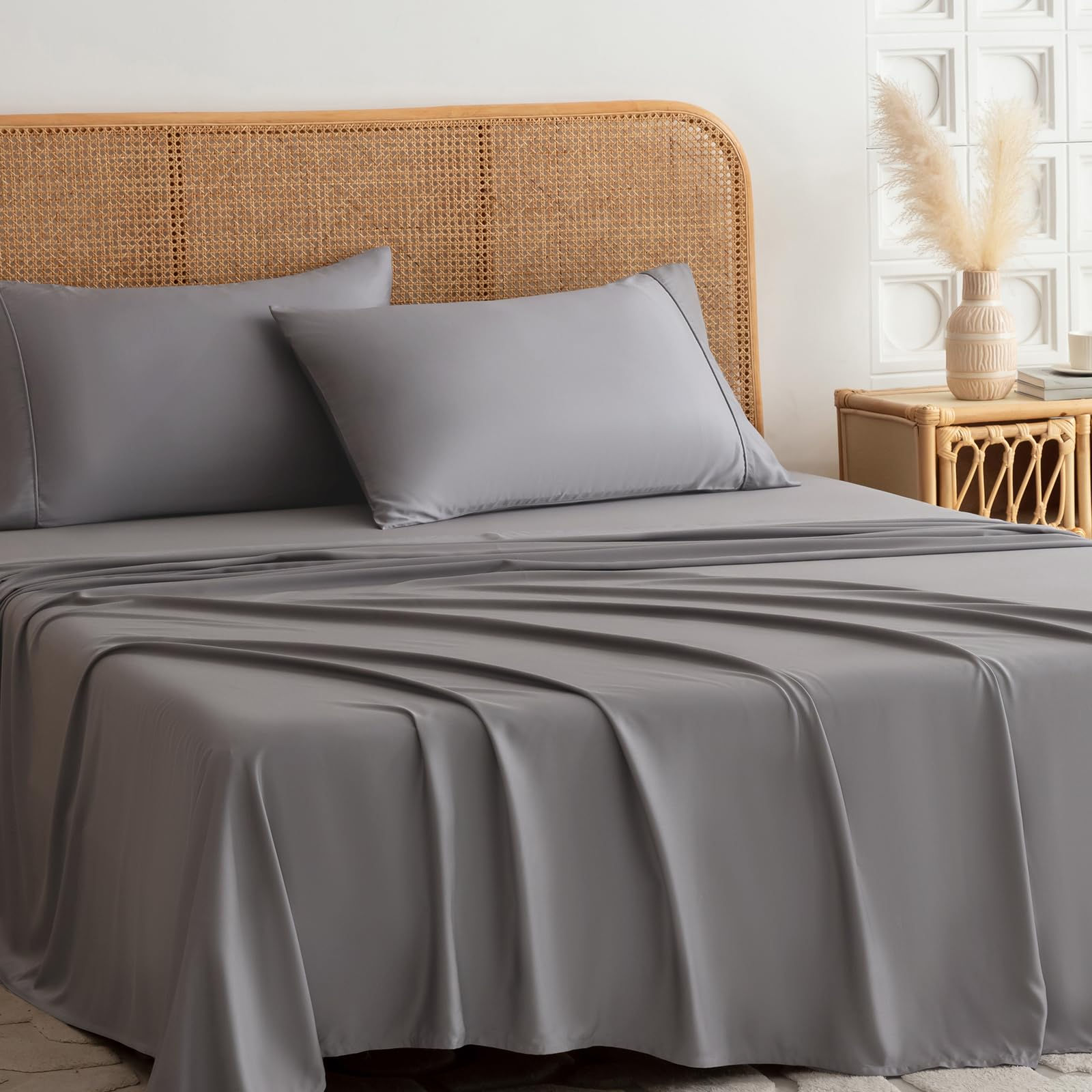 Gray bed sheet set with matching pillows on a bed.