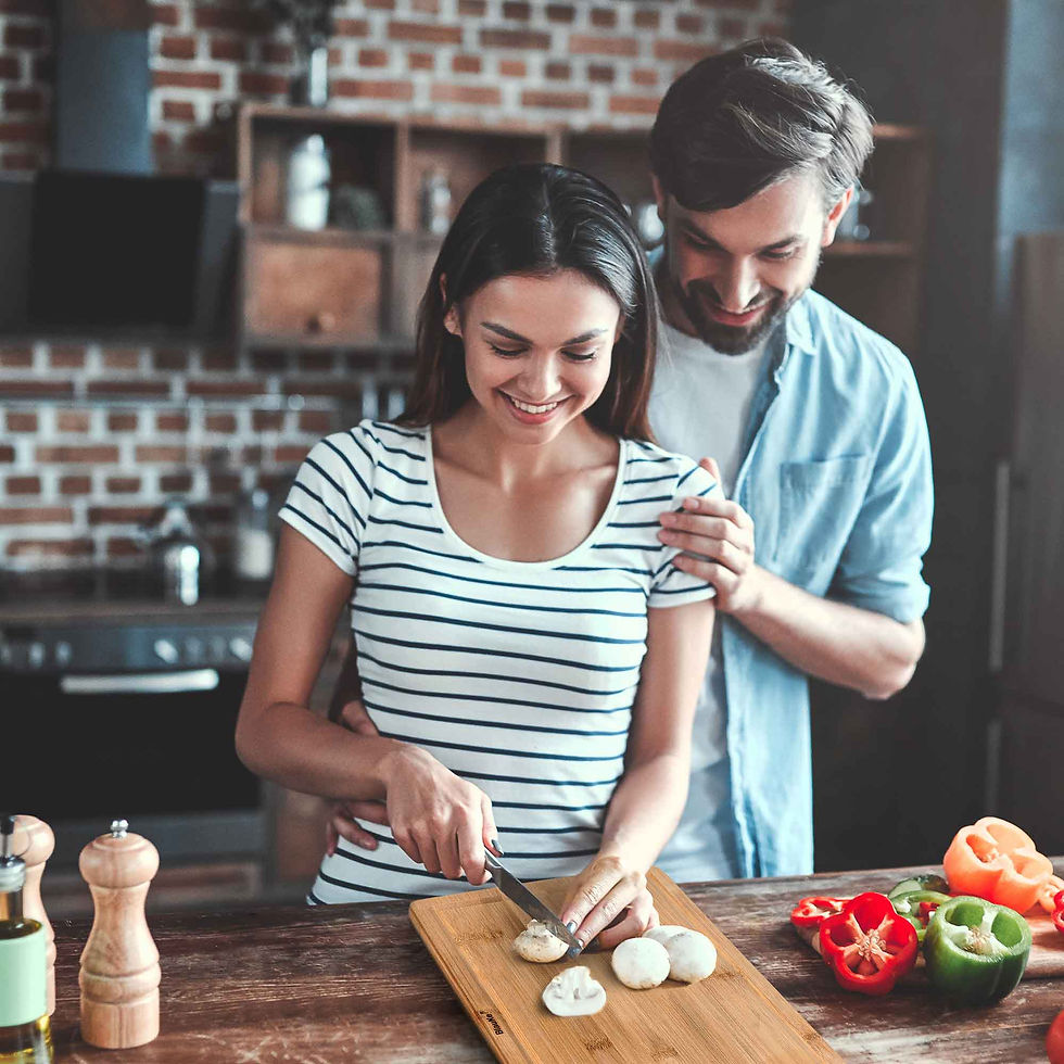 Thumbnail: Couple smiling while slicing vegetables in a kitchen