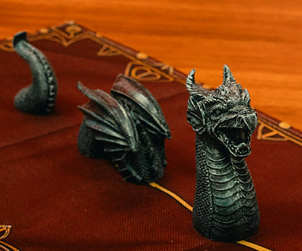 Dragon over a banner, a sandclock and dice tower