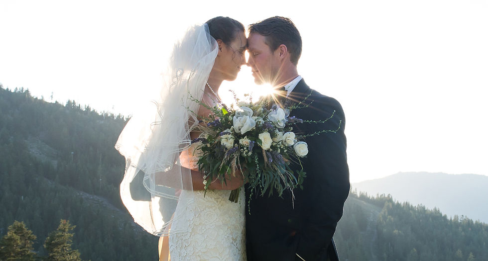 Wedding couple posing on a mountain top during their destination elopement photoshoot