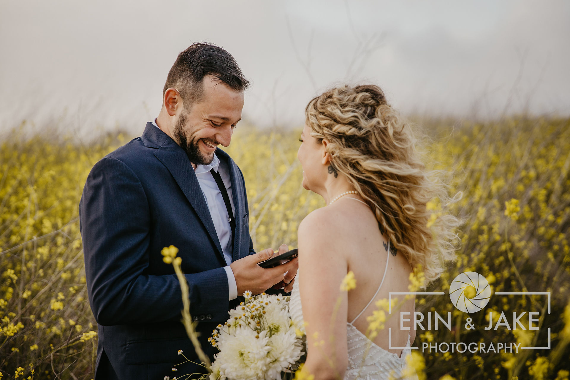 Bride and groom exchange wedding vows in a field of flowers during their destination wedding elopement