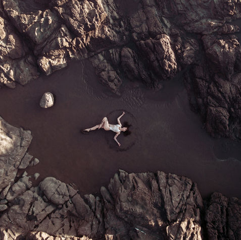 Model posing on the beach for drone photograph