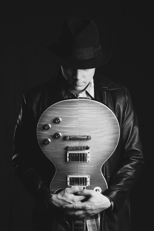 Noir portrait of guitar player in a Los Angeles photography studio