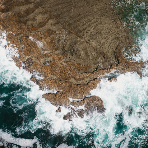 Aerial image of waves crashing against rocks in Palos Verdes, California
