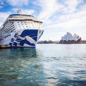 A large cruise ship from Princess Cruise Line is moored in the water, inviting guests for a journey in Australia.