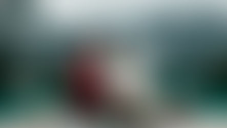 A Couple sit in front of a lake at the foot of mountains in Iceland