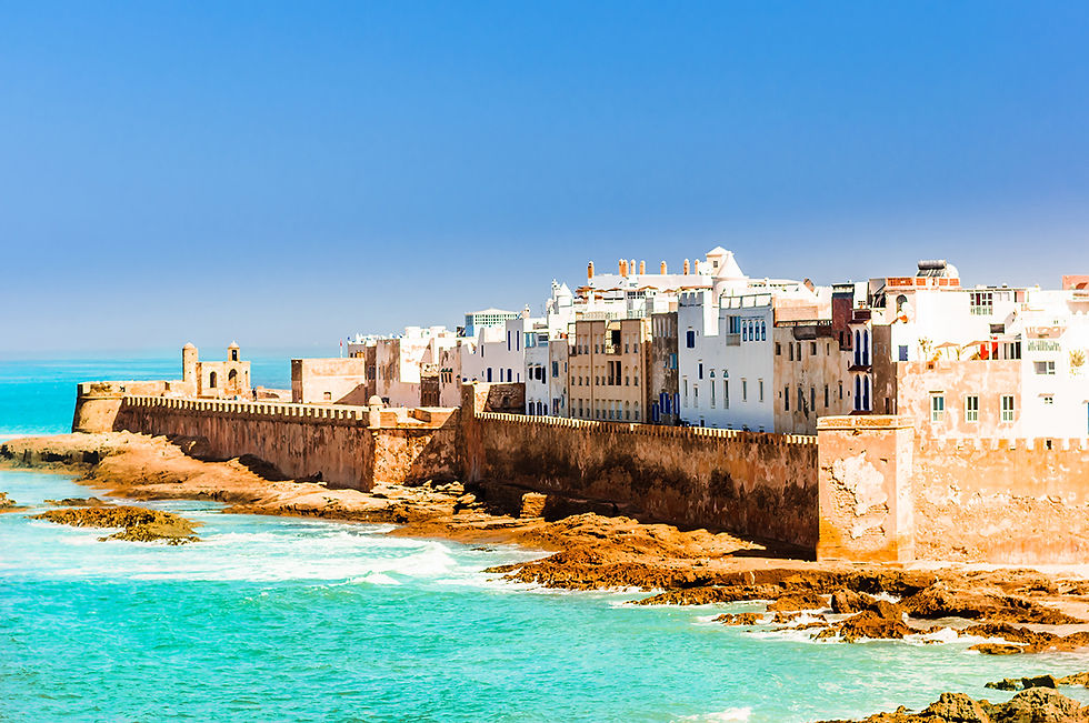 Bright blue sky meets teal ocean waters with a view of historic Essaouira in Morocco nestled on the coast of the Atlantic Ocean
