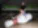 Sara Rouk, mental coach and former competitive bowler, sitting on a giant bowling pin holding a bowling ball