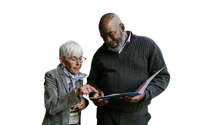 Two professionals collaborating over a document against a cosmic background, symbolizing strategy and vision