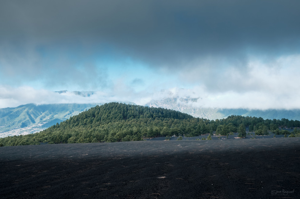 View across the ash at Tajogaite with dark cloudy sky