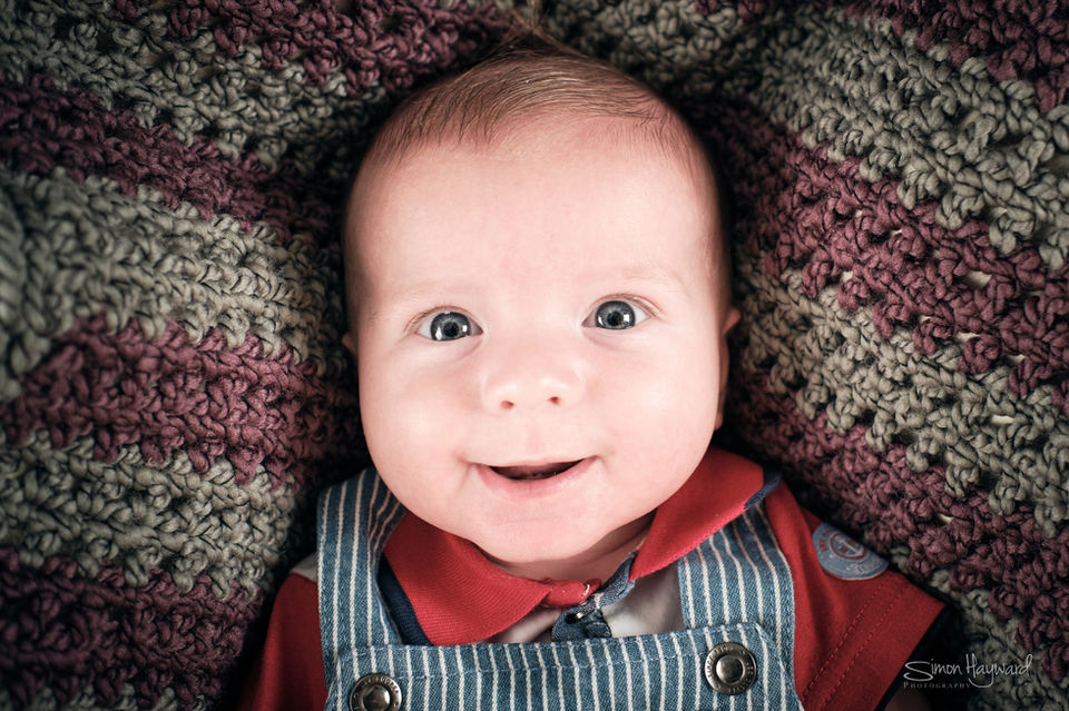 Baby boy looking directly at the camera and smiling