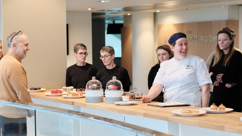 Michel Roux and others discussing food at the Epsom Chez Roux Tasting candid photography