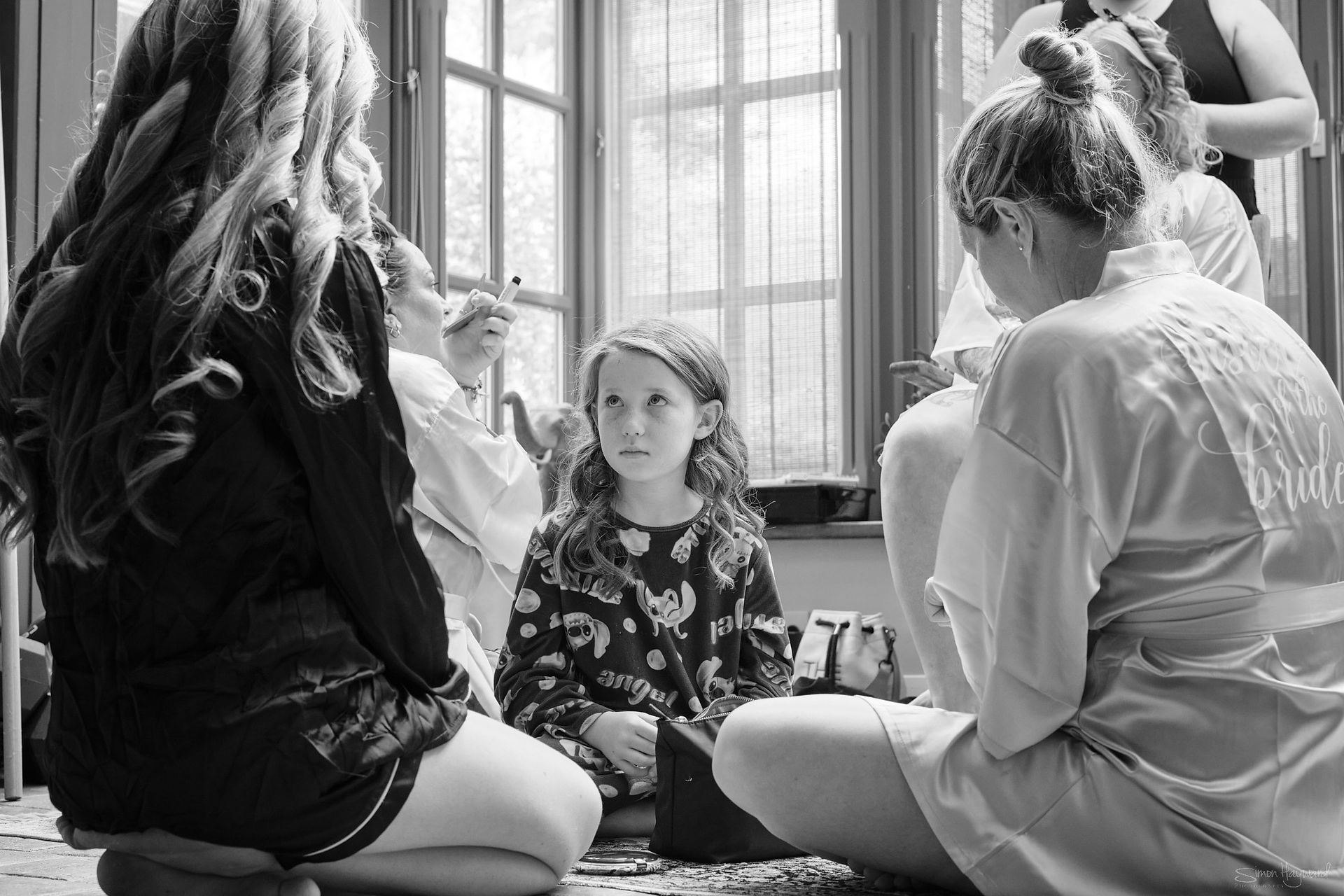 A young girl sat on the floor looking sad