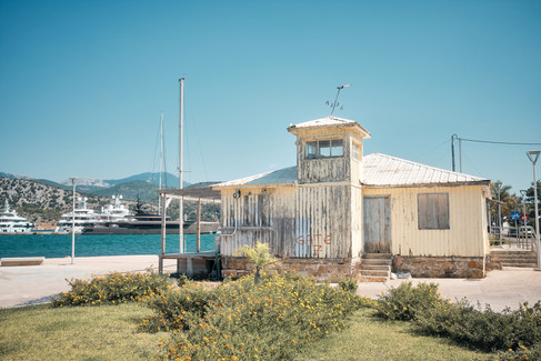 A yellow derelict building in Argostoli port