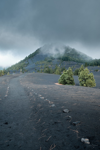 View across the ash at Tajogaite with dark cloudy sky