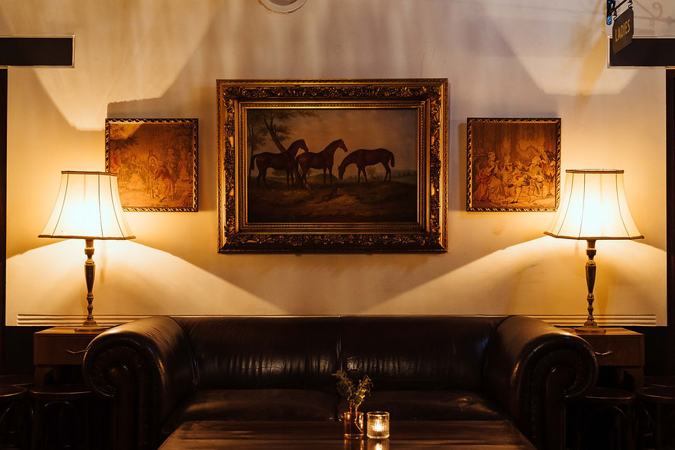 This is the grand staircase room with couch and horse