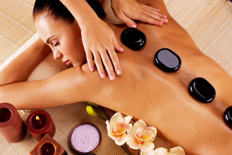 Close-up view of massage oils and stones arranged for a therapeutic session