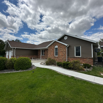 Residential exterior house painting project with careful preparation, masking and smooth professional finish.