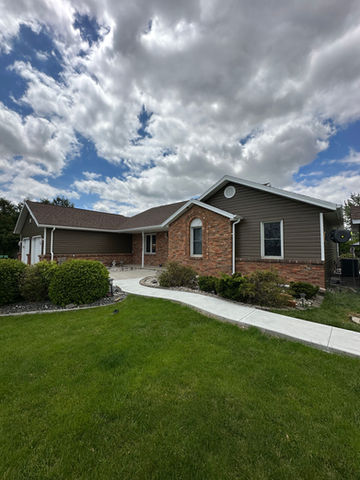 Residential exterior house painting project with careful preparation, masking and smooth professional finish.