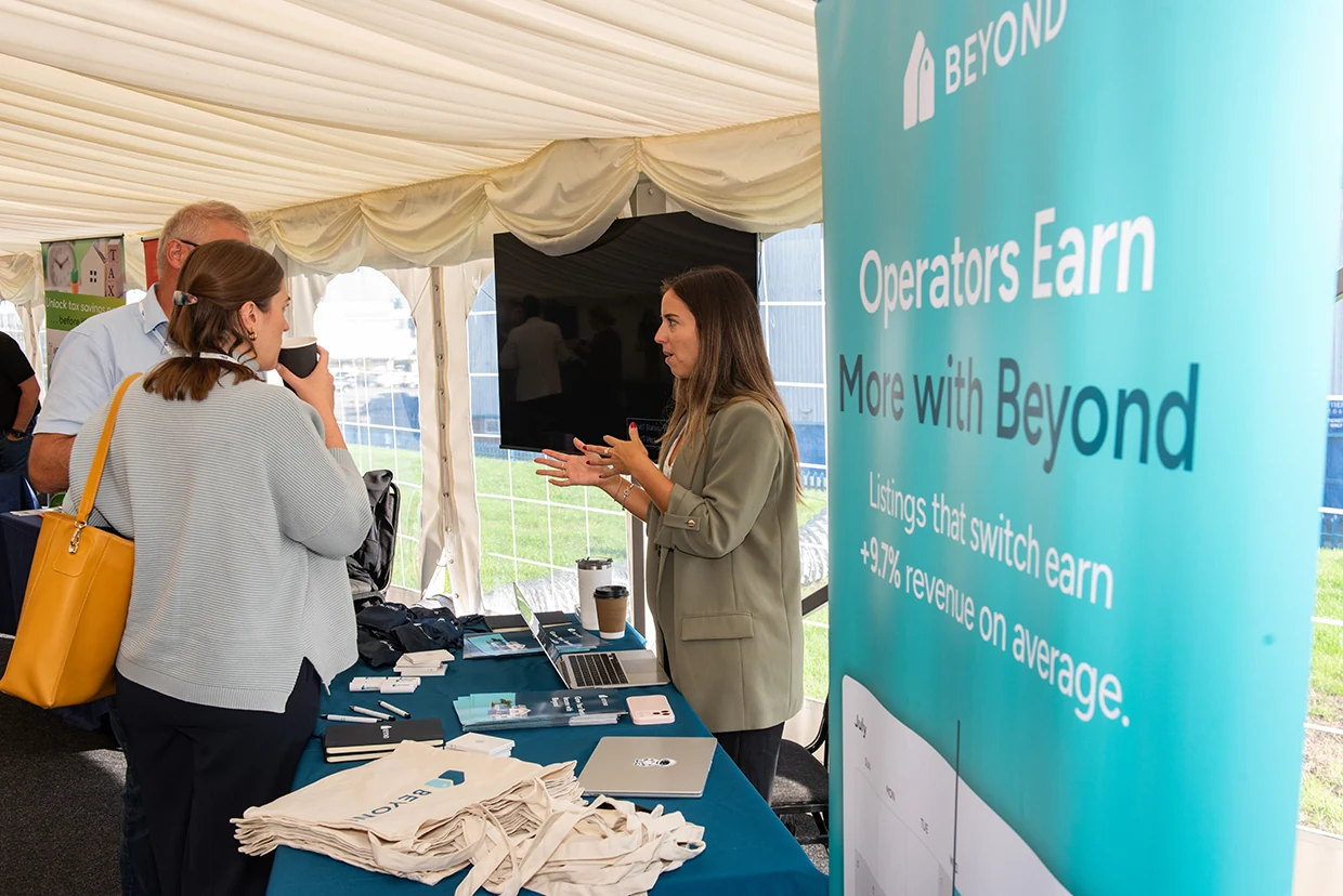 A Beyond representative speaking with attendees at the exhibitor stand in Nottingham