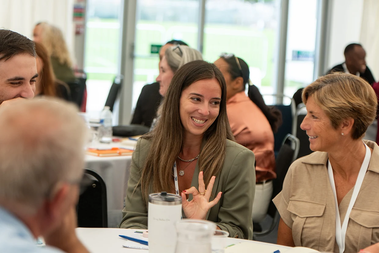 Attendees smiling and sharing ideas around a table at the Nottingham Roadshow in 2026