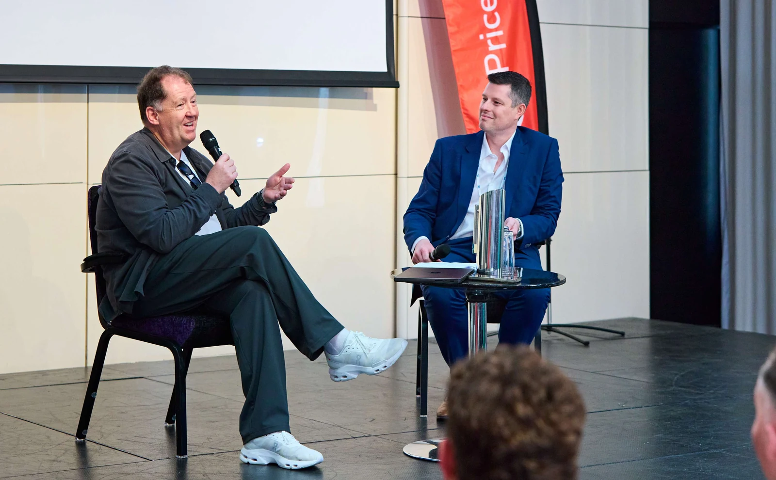 Two speakers in conversation on stage at the London Roadshow