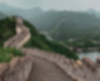 the great wall of China with lush, green mountains in the background