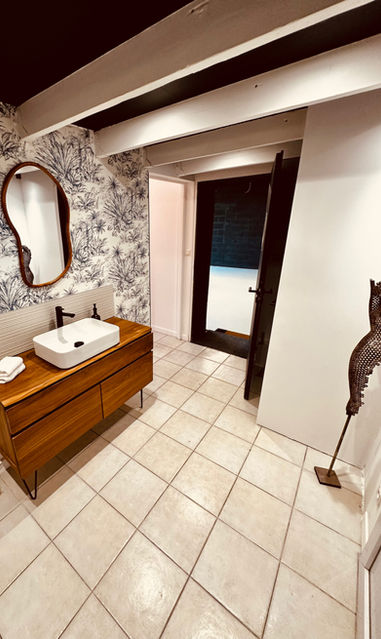 Salle de bain moderne avec vasque en bois et miroir.