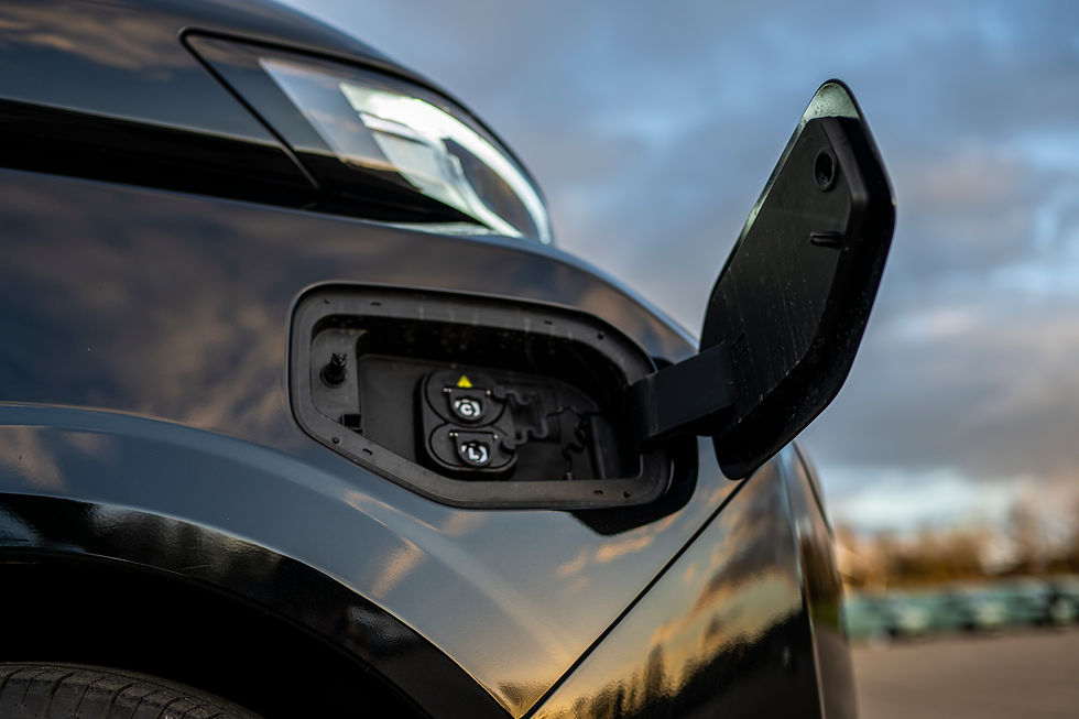 Close-up view of an electric van charging at a depot charging station