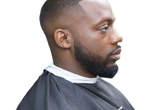 Black man with a fresh fade, clean lineup and groomed beard