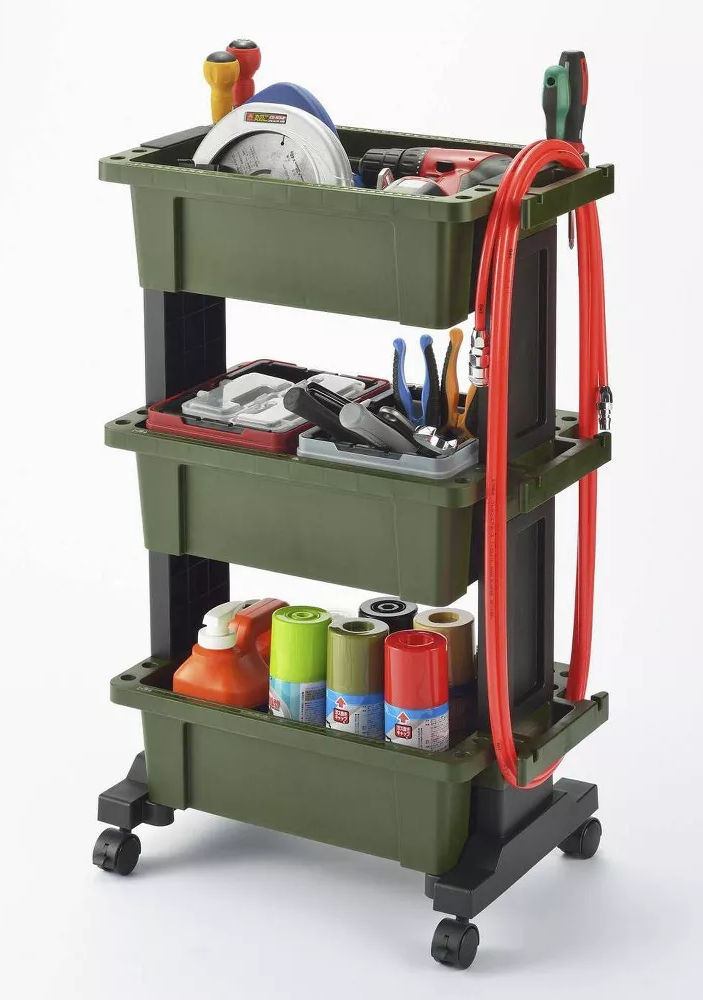 Green utility cart with three shelves holding tools, spray cans, red hose, and cleaning supplies. Items are neatly organized.