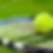 Tennis ball resting on a racket on lush green grass, showcasing vibrant yellow and blue colors. Peaceful outdoor setting, no text visible.