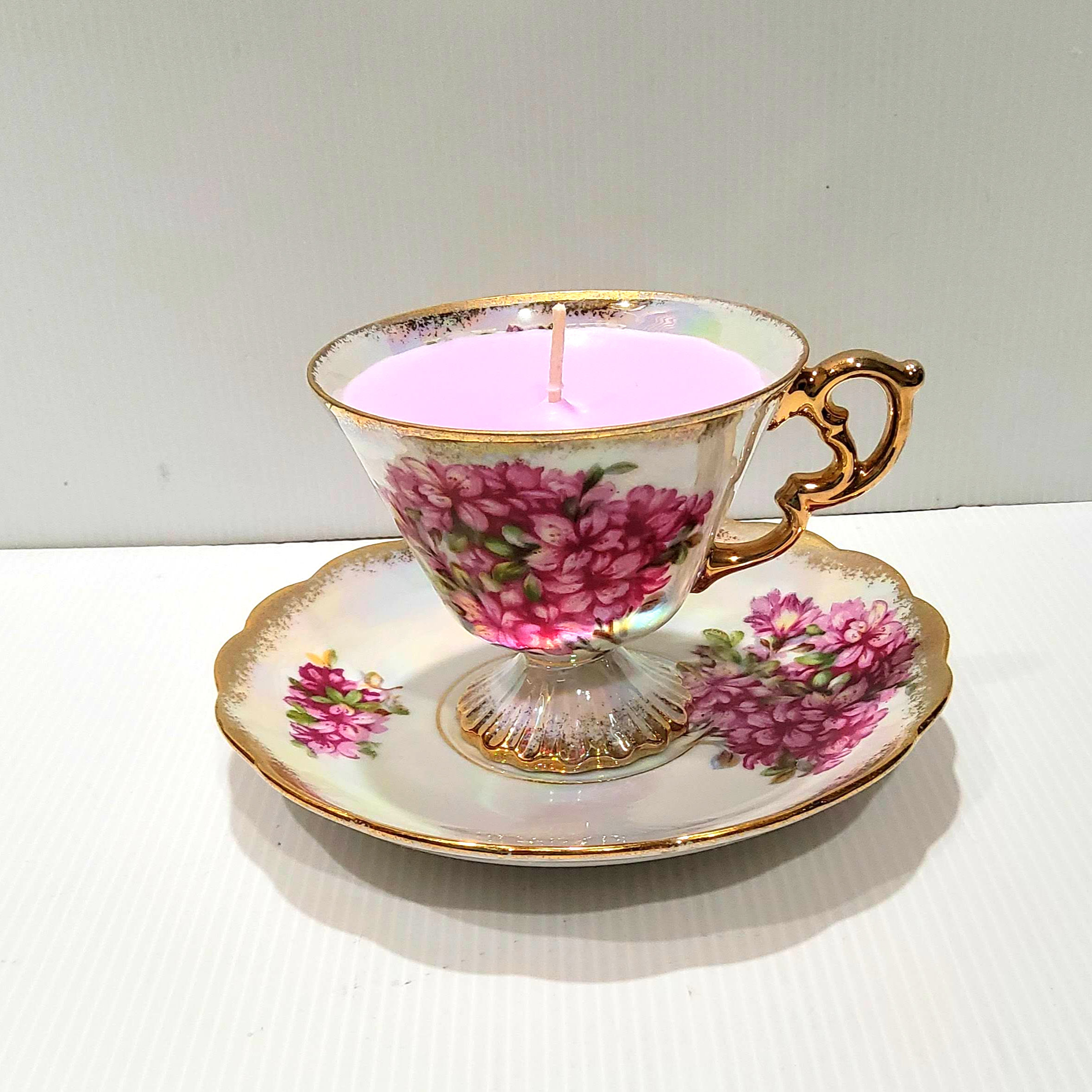 Handpoured soy candle in a vintage pearlescent china teacup and saucer.
