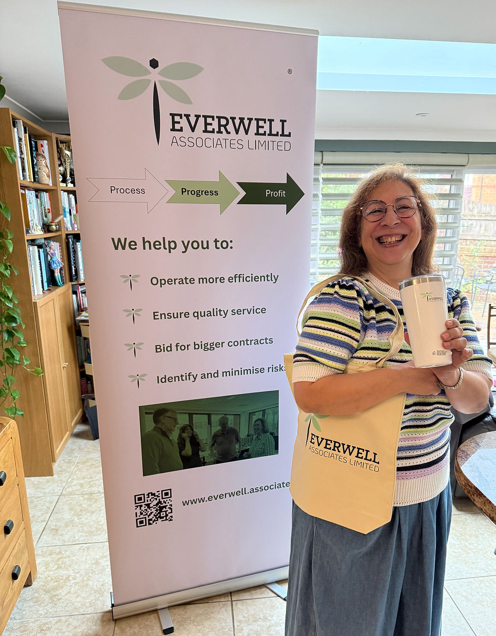 Rashne holding Everwell Associates Merchandise in front of a banner