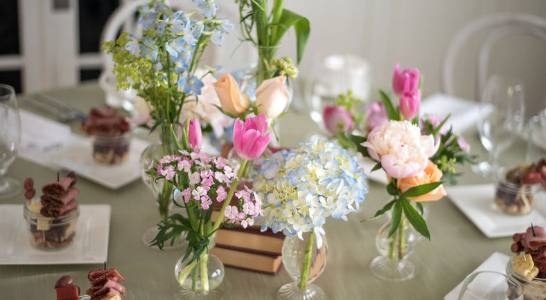 mini vases with flowers on table