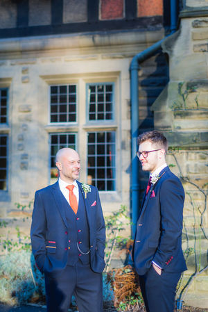 Jesmond Dene House wedding, Newcastle Upon Tyne. two men in suits are standing in front of a building