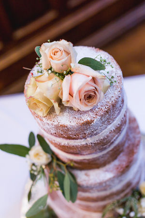 Jesmond Dene House wedding, Newcastle Upon Tyne. a wedding cake with roses on top of it